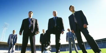 Serious Businessmen Playing Soccer