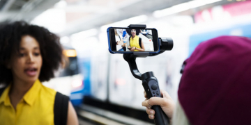 Young adult woman traveling and vlogging social media concept