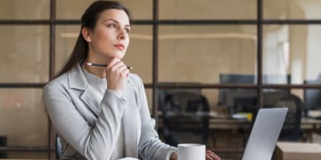 contemplating businesswoman sitting front laptop office 23 2148187150