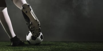 crop athlete kicking soccer ball 23 2147817301