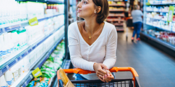 woman shopping grocery store by refrigerator 1303 16013