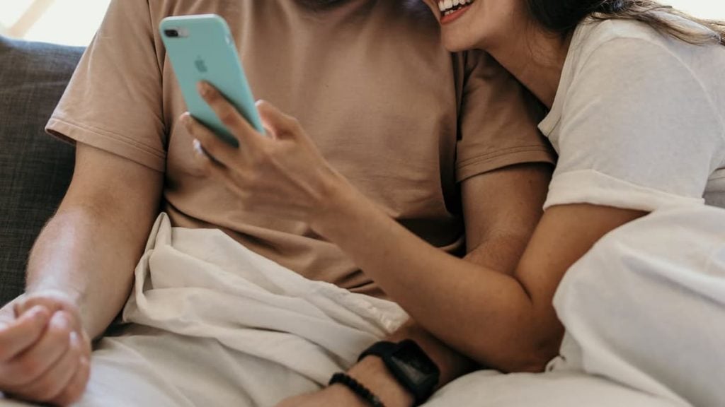 Pareja lee sobre Club House: qué es y como funciona