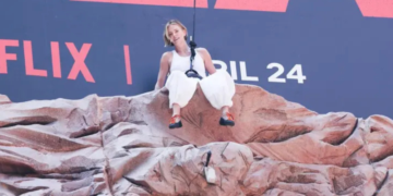 Charlize Theron escala un billboard en Times Square para promocionar 'Apex'